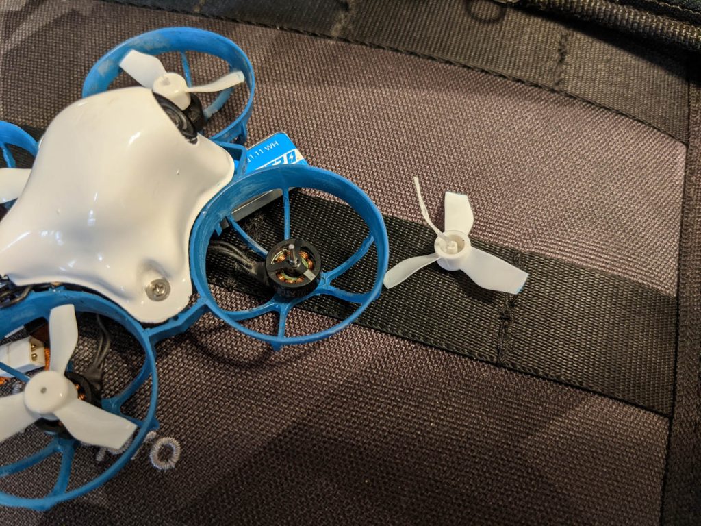 Micro whoop quad with floss sticking out of propeller