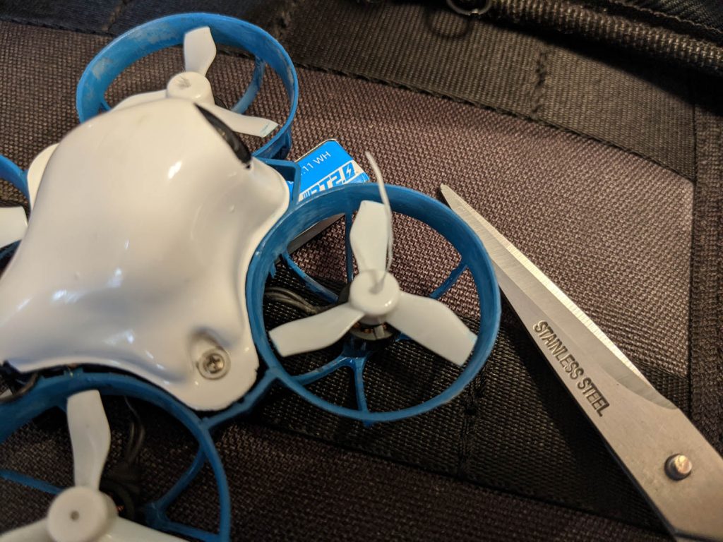 Micro whoop quad with floss sticking out of propeller